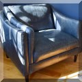 F05. Blue leather club chair. 33”h x 40”w x 35”d 